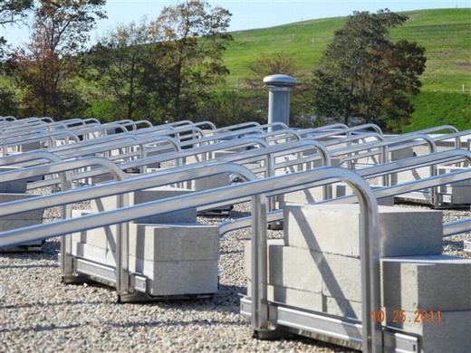 View of non-penetrating ballasted rails on gravel roof